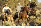 stock-photo-three-cowboys-galloping-350787827.jpg